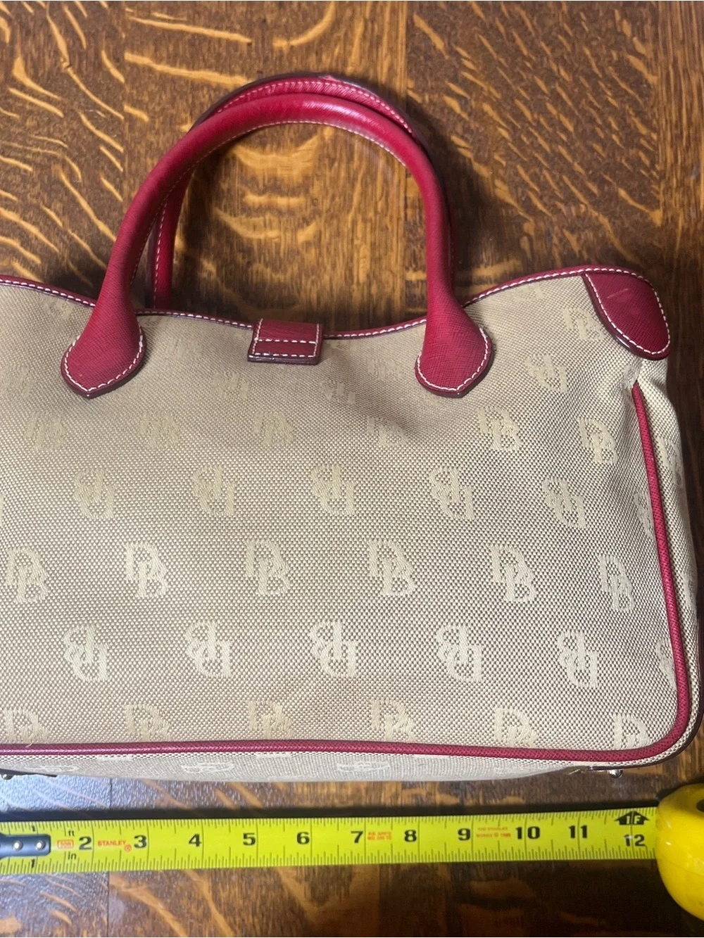 Dooney & Bourke Tan Monogram Canvas Satchel with Red Leather Trim Silver Lock.